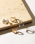 Conchi gold huggie earrings by PIERETTI styled with modern look, elegant small gold hoops