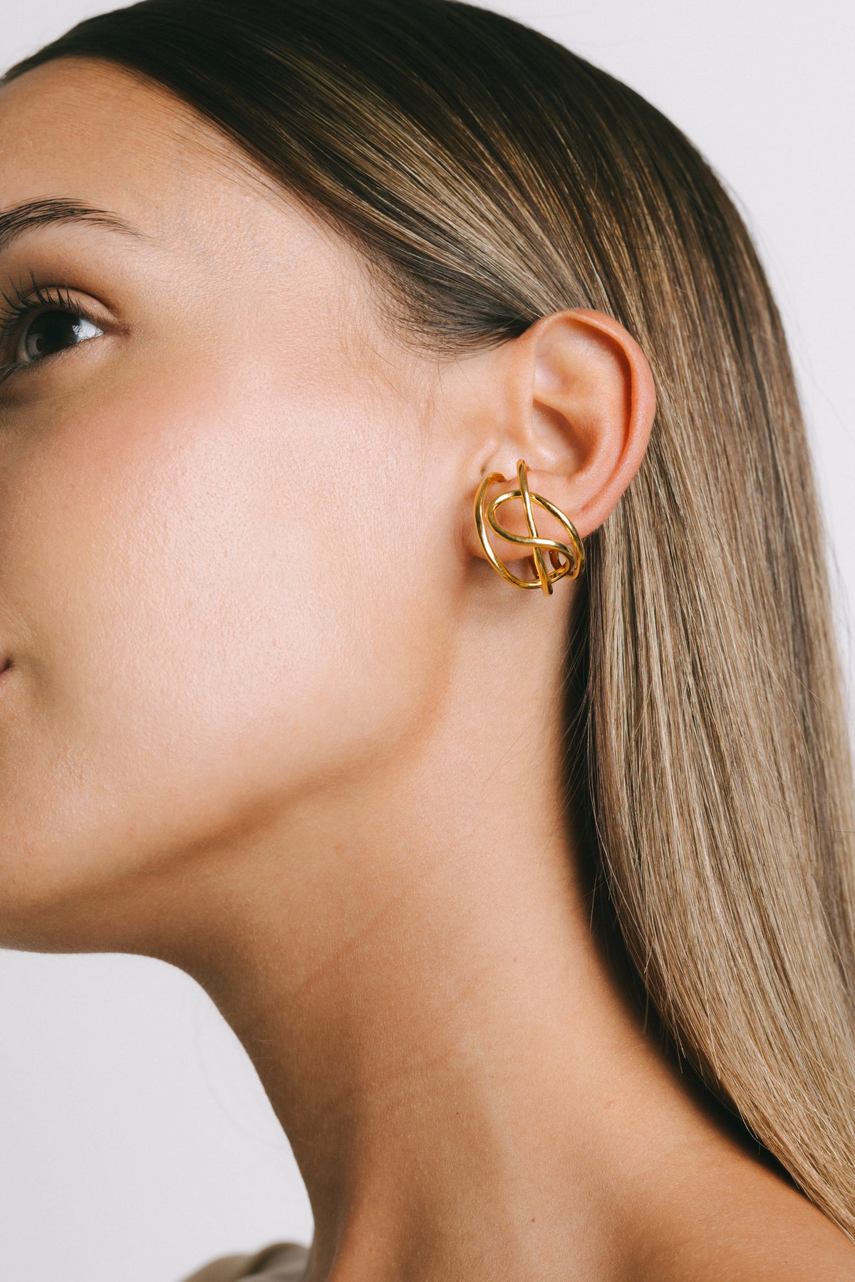 Model wearing Fefe Large Stackable Ear Cuff in Gold Plate by Pieretti