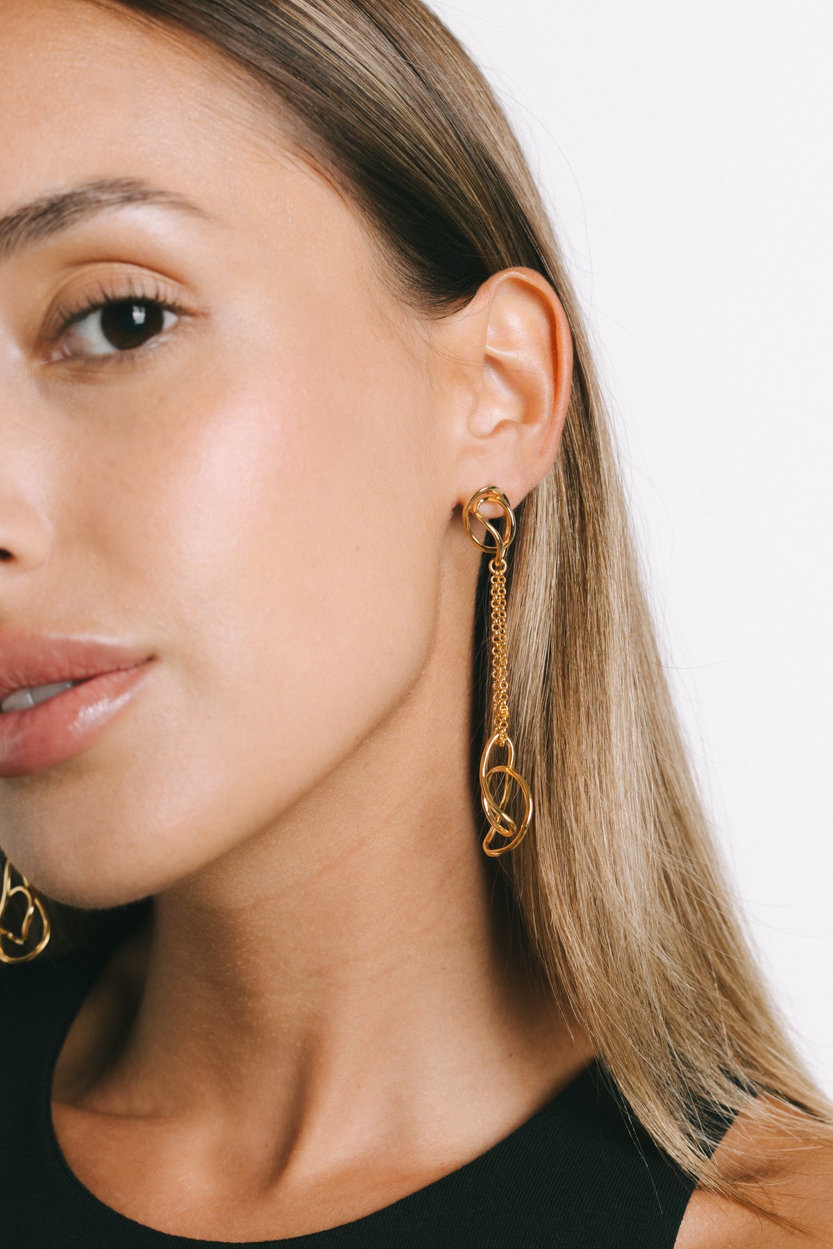 Model wearing Fiorella Chain Drop Earrings in Gold Plate by Pieretti