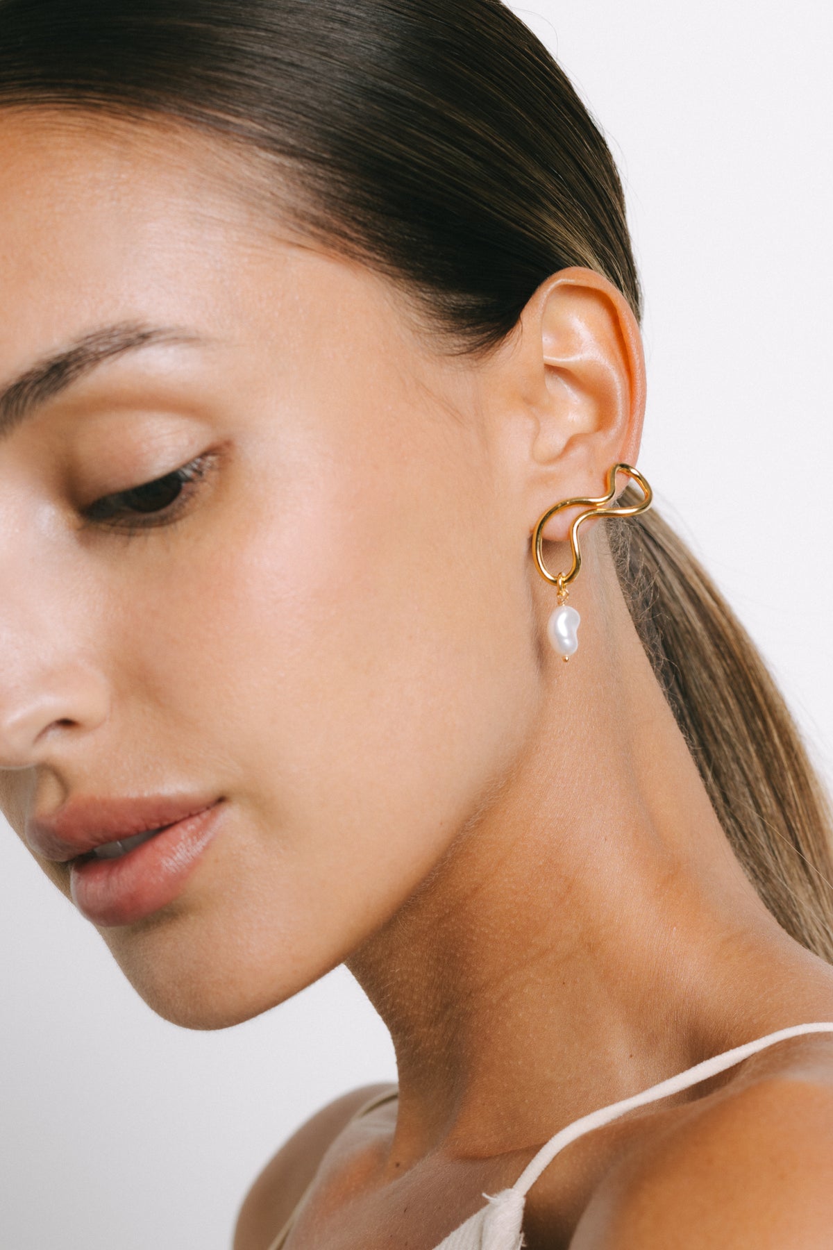 Model wearing Filipa Freshwater Pearl Drop Earrings in Gold Plate by Pieretti