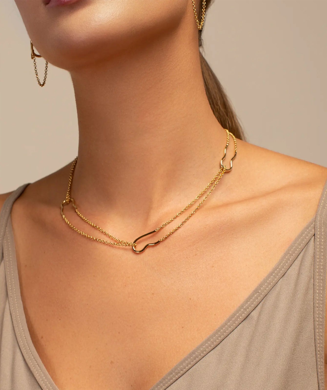 Nicole gold double chain necklace by PIERETTI worn on neck, lightweight layered necklace