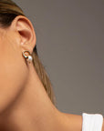 Clara freshwater pearl earrings by PIERETTI, natural pearl detail with polished finish