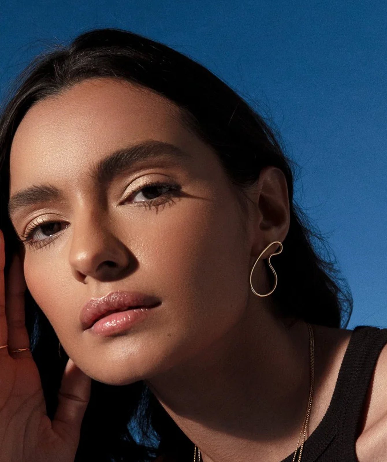 Naty sculptural earrings by PIERETTI, polished gold-plated curved design detail