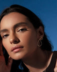Naty sculptural earrings by PIERETTI, polished gold-plated curved design detail