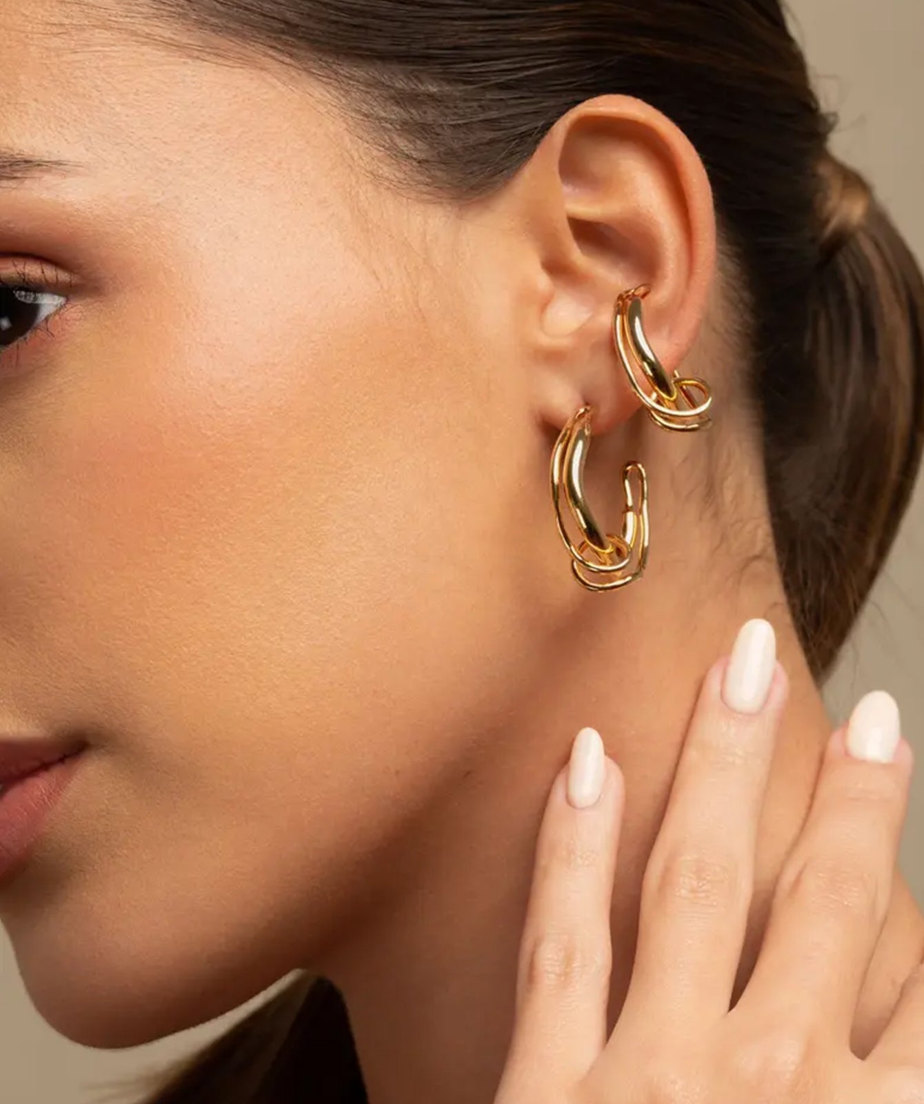 Colette gold ear cuff by PIERETTI worn on ear, twisted small ear cuff no piercing