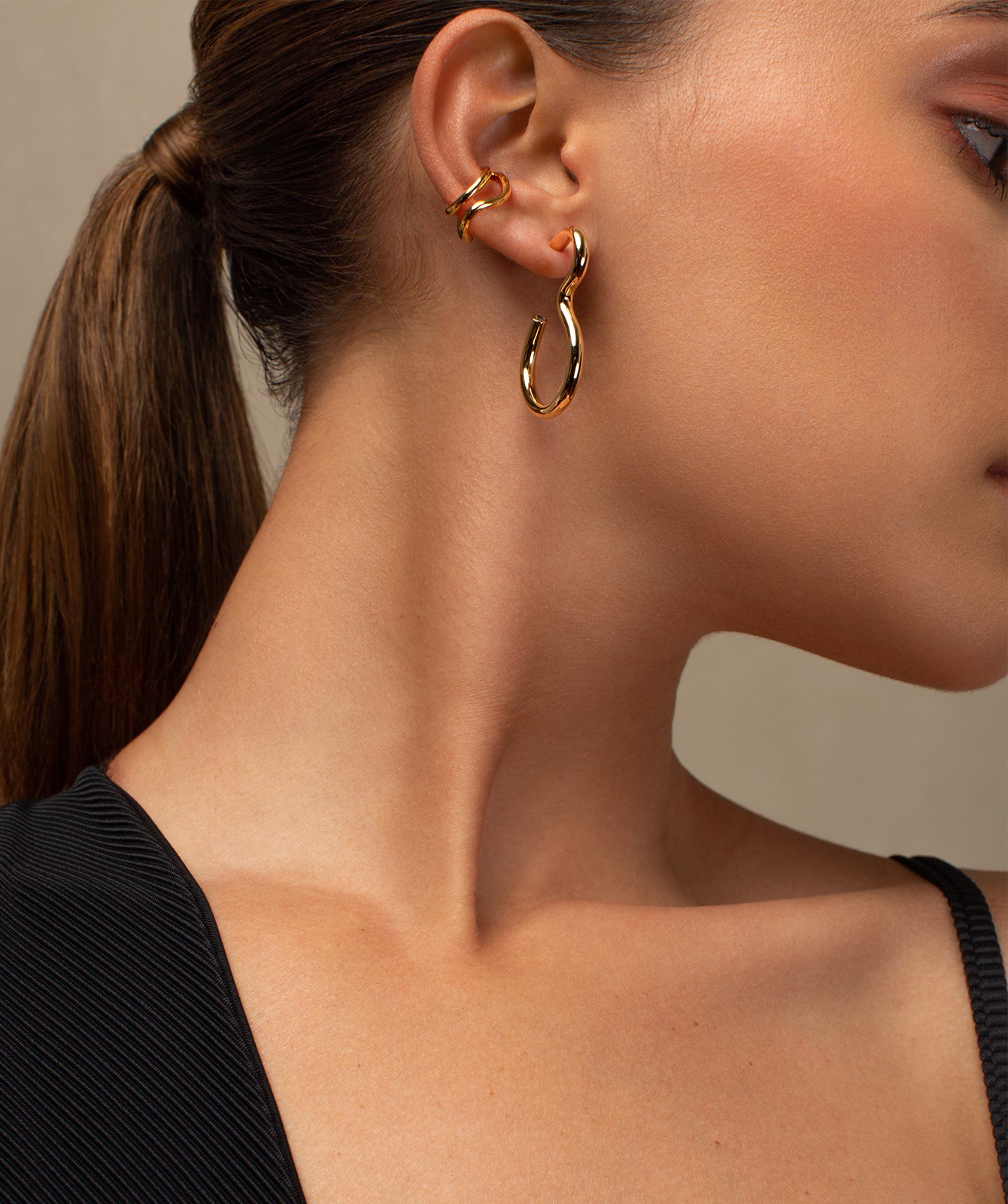 Naeva gold ear cuff by PIERETTI worn on ear, double band ear cuff no piercing