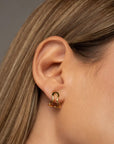 Conchi gold huggie earrings by PIERETTI, polished 18K gold-plated hoop design detail