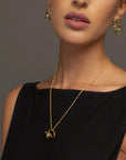 Celine gold pendant necklace by PIERETTI worn on neck, lightweight chain necklace