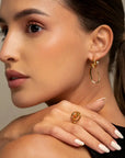 Calei gold zirconia earrings by PIERETTI worn on ear, lightweight drop earrings with stones