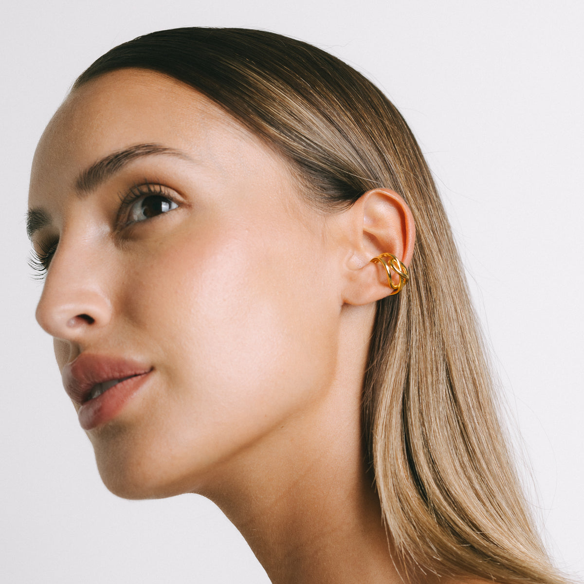 Model wearing Fefe Small Stackable Ear Cuff in Gold Plate by Pieretti
