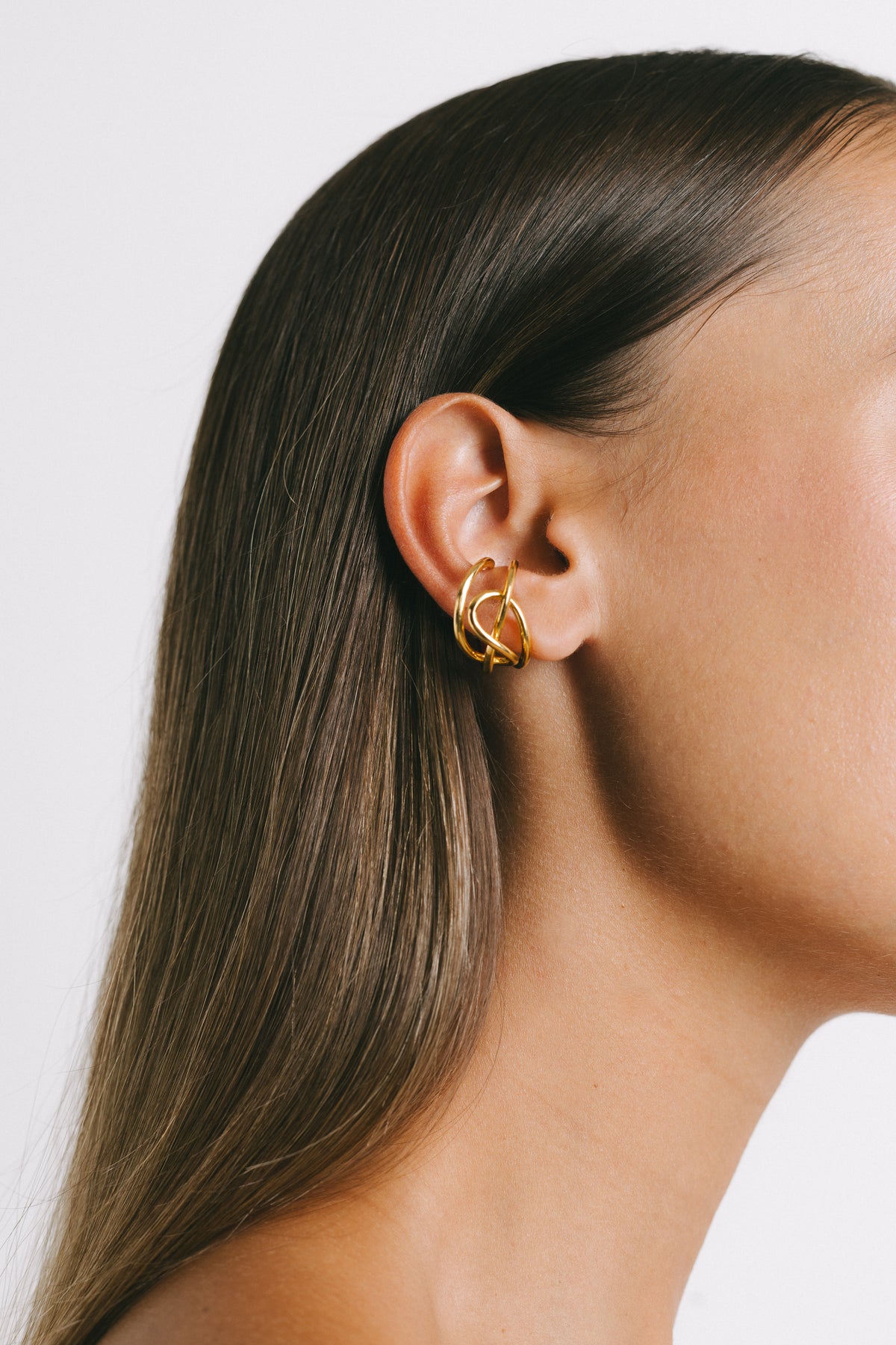 Close-up of a model wearing Fefe Medium Stackable Ear Cuff in Gold Plate by Pieretti