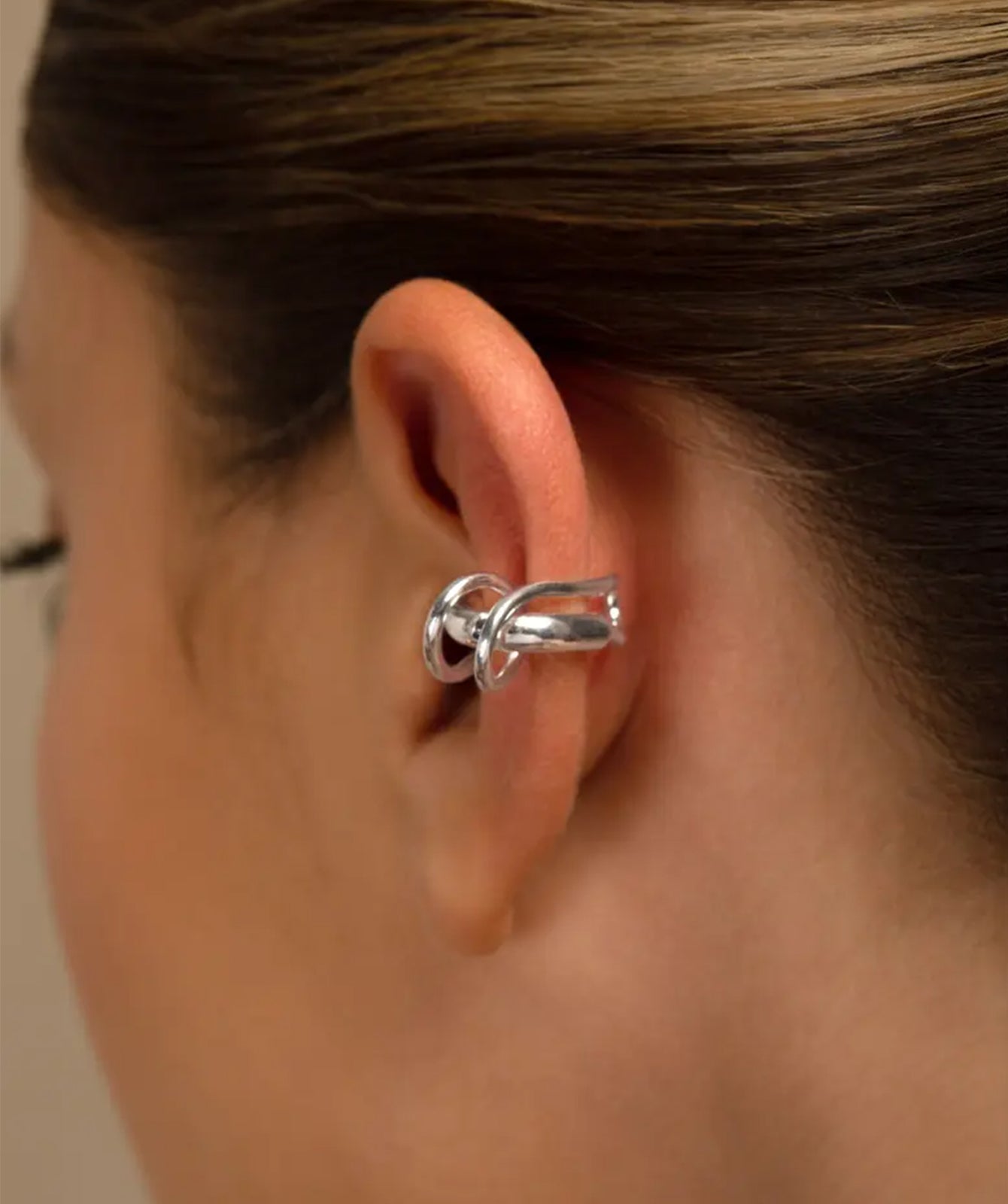 Clau silver ear cuff by PIERETTI worn on ear, twisted ear cuff no piercing