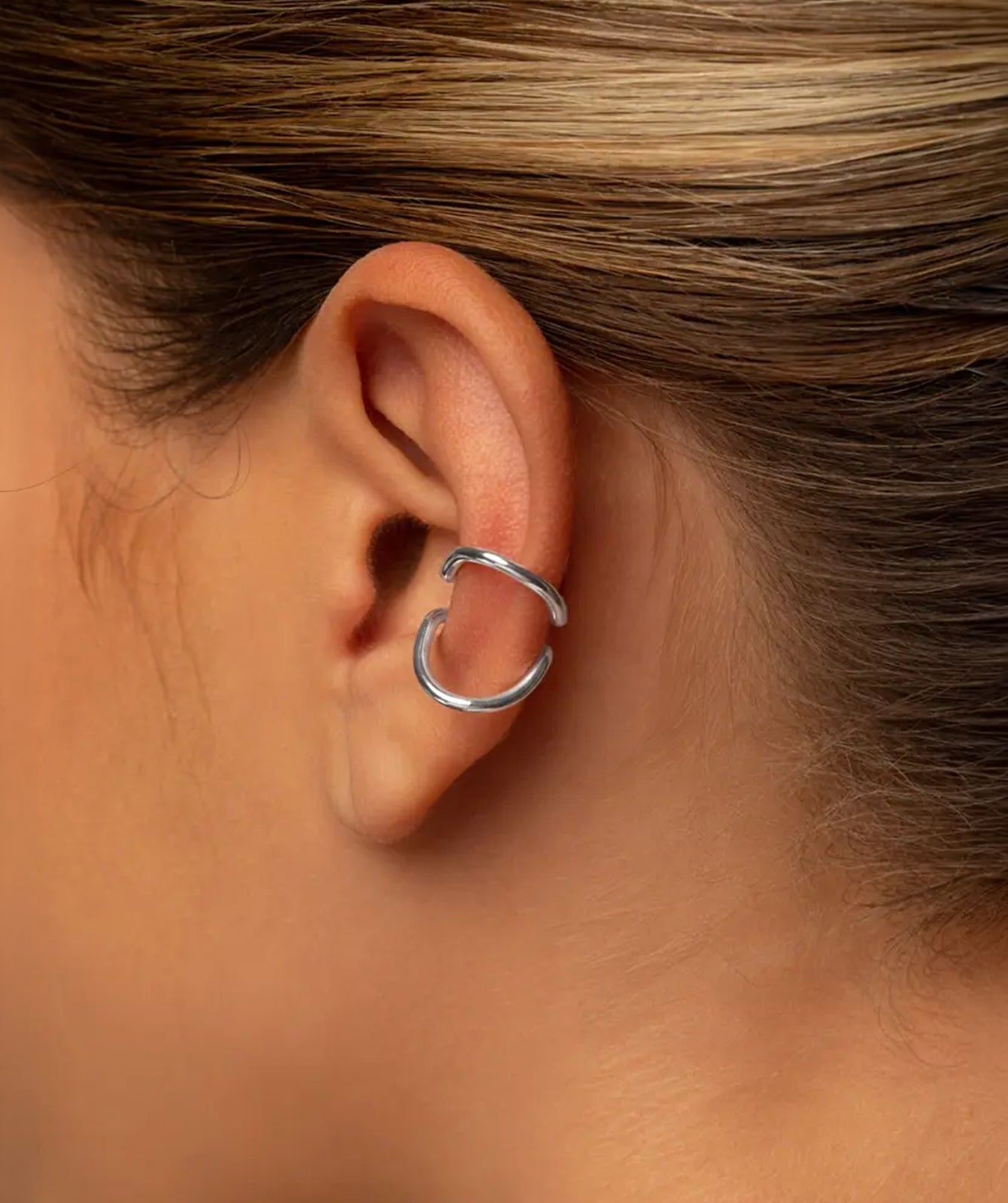 Nora silver ear cuff by PIERETTI worn on ear, minimalist ear cuff no piercing