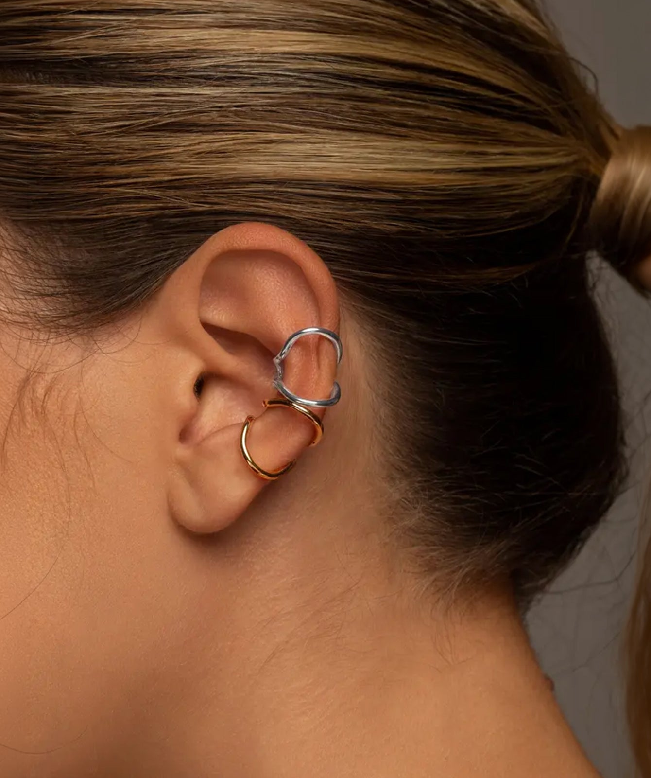 Nora silver and gold ear cuff by PIERETTI, polished silver design detail