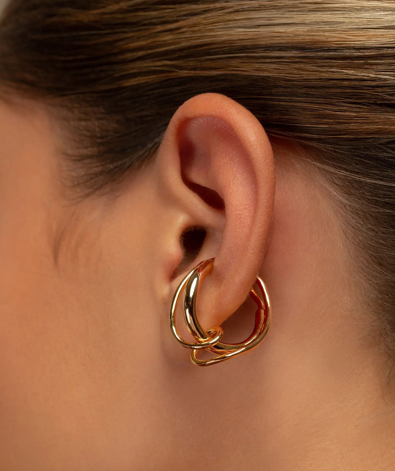 Colette twisted ear cuff by PIERETTI, polished gold-plated sculptural design detail