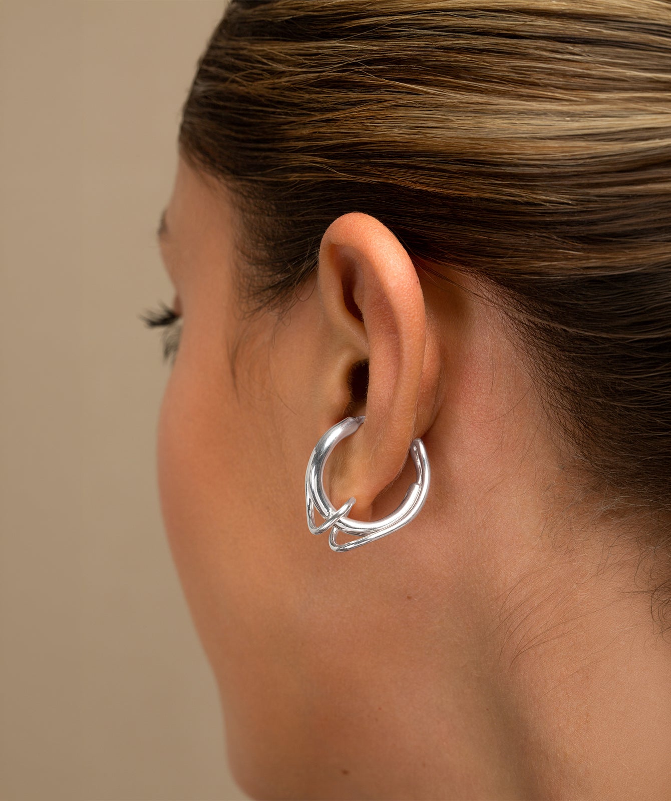 Colette silver ear cuff by PIERETTI worn on ear, twisted small ear cuff no piercing